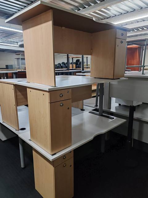 Second-hand maple desks with white tops and pedestals