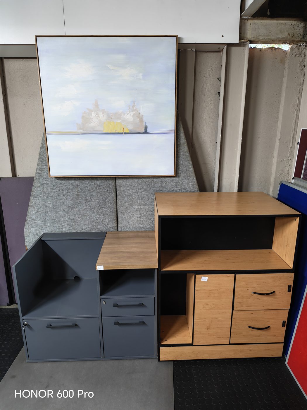 Second-hand cabinet units and framed artwork