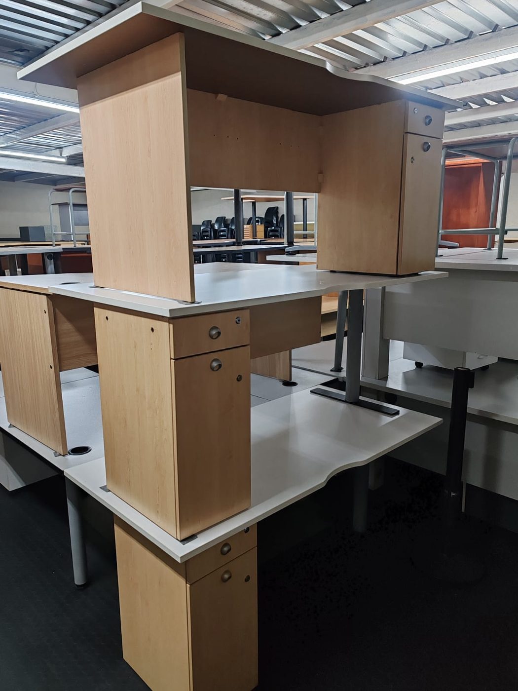 Second-hand maple desks with white tops and pedestals